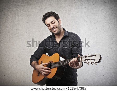 handsome musician playing guitar handsome musician playing guitar