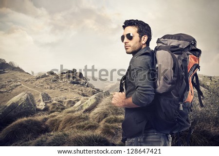 Handsome Young Man With Backpack In The Mountains