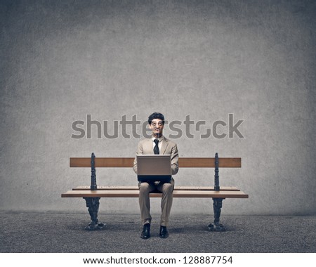 businessman working with laptop on a bench