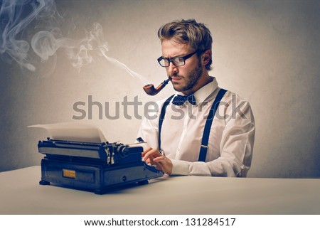 handsome journalist writing with typewriter