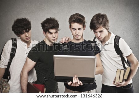 group of friends watching laptop together