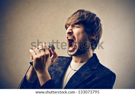 man singing with microphone