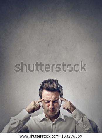 man thinks intensely on gray background