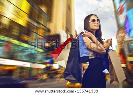 beautiful woman goes shopping in the city