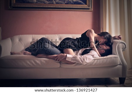 Young Lovers Kissing On The Couch