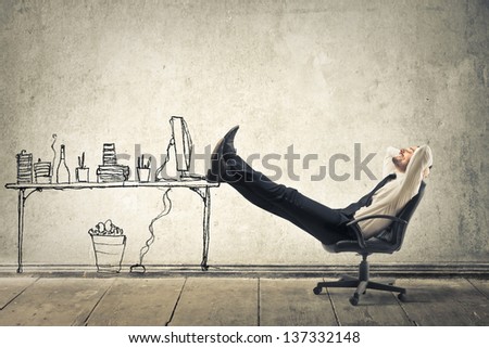 Young Businessman Relaxes Sitting In The Office