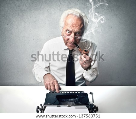 senior journalist writes with vintage typewriter