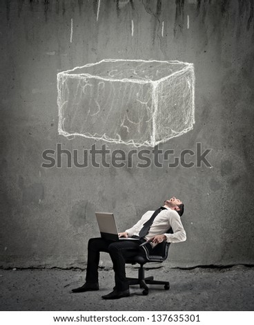 young businessman crushed by a large boulder