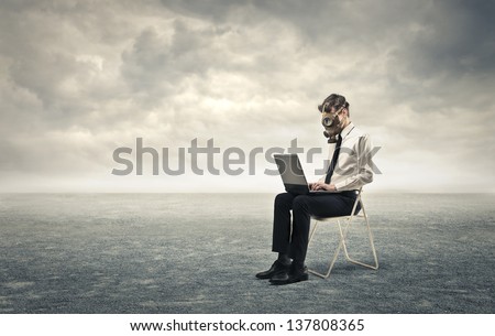 young businessman working with gas mask