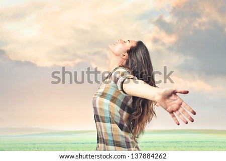 beautiful girl opens her arms to make a big breath