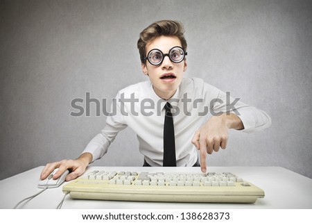 young businessman writing with the computer keyboard