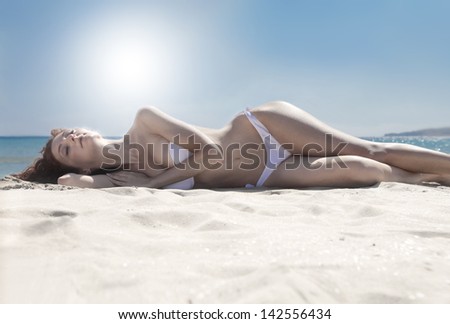 beautiful woman sunbathing on the beach