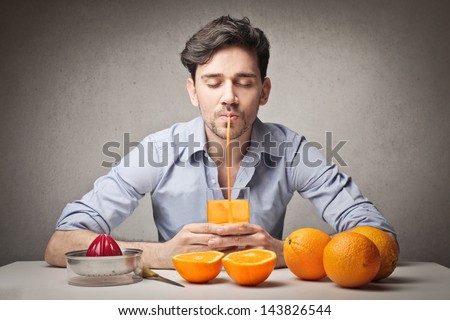 young man drinking orange juice