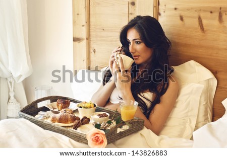 Beautiful Woman Having Breakfast In The Hotel Bed