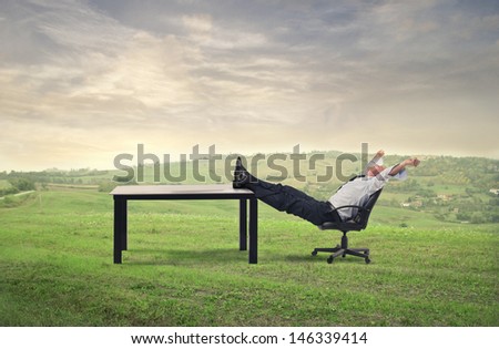 businessman relaxes sitting in the countryside