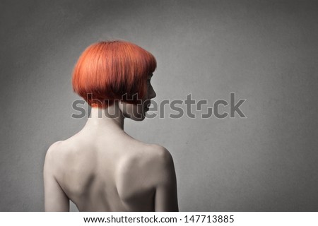 beautiful woman with red hair turned back