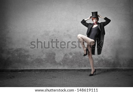 beautiful woman dancing with cylinder and tail-coat