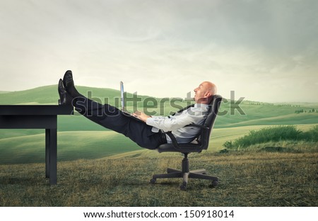 bald businessman relaxes in the countryside
