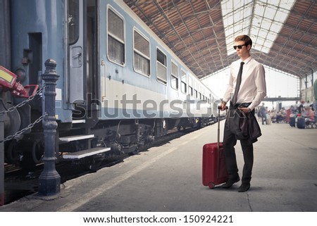 young traveler with trolley waiting to leave at the station
