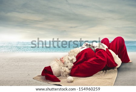 Santa Claus sunbathing lying on the beach Santa Claus sunbathing lying on the beach