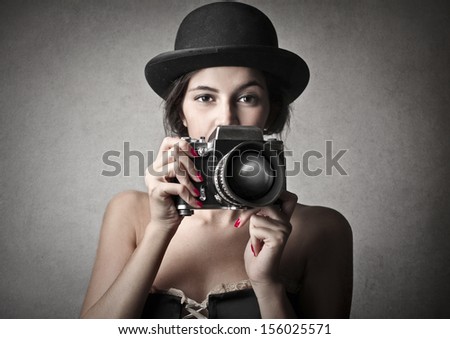 Beautiful Woman With Bowler Hat And Vintage Camera