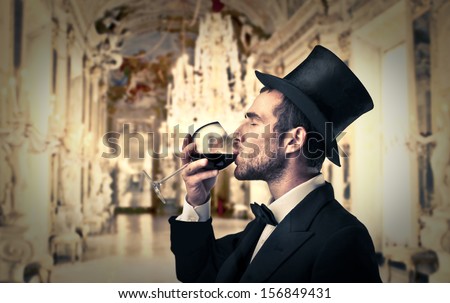 Rich Man Drinking A Glass Of Red Wine In A Luxurious Palace