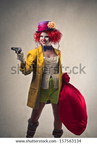 beautiful robber clown with gun and big sack of money
