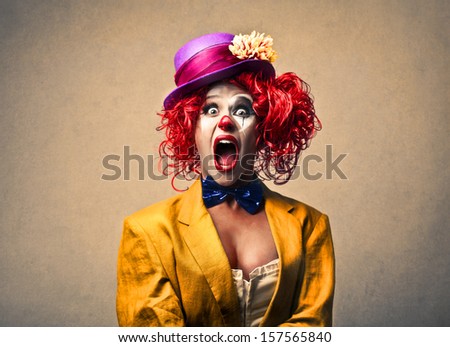 portrait of a beautiful clown screaming