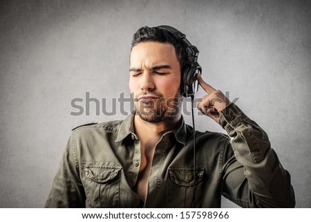 young man listens music with headphones