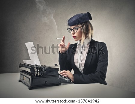 beautiful blonde woman writes with a typewriter