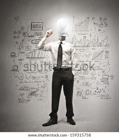 businessman writing on the wall with the head in the shape of a light bulb