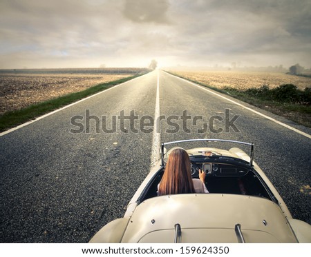 Beautiful Woman Traveling On A Vintage Car
