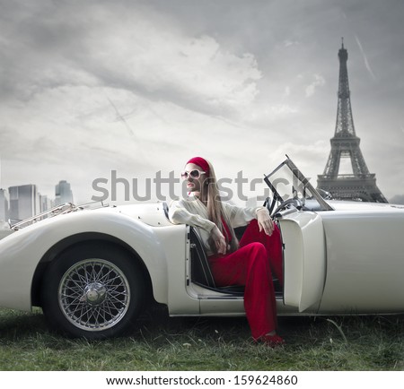 beautiful woman on a vintage car in Paris