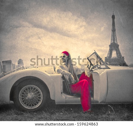 beautiful woman on a vintage car in Paris