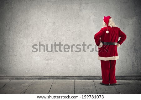 Santa Claus looking the wall