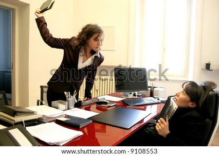 Two woman having an angry confrontation in a office