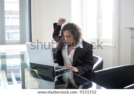 Angry executive woman attacking her computer