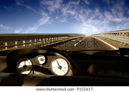 Car, speed indicator, way and sky
