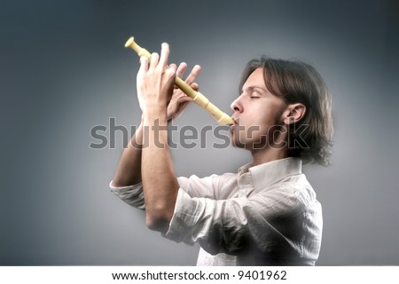 a young man playing a flute