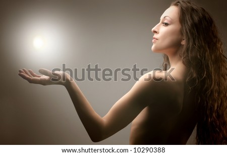 a portrait of a beautiful  woman with a light on the hand
