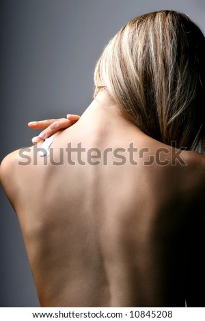 a back of a woman with a body-lotion
