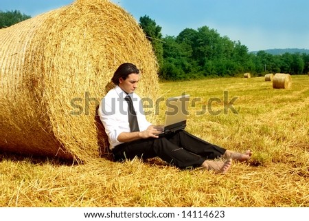 a business man in a countryside with a laptop