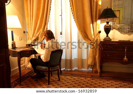a man  write in  a luxury hotel room