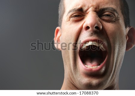 a close up of a man screaming