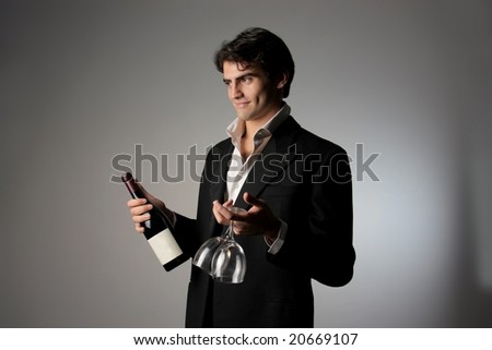 young beautiful man with a bottle of wine and glass