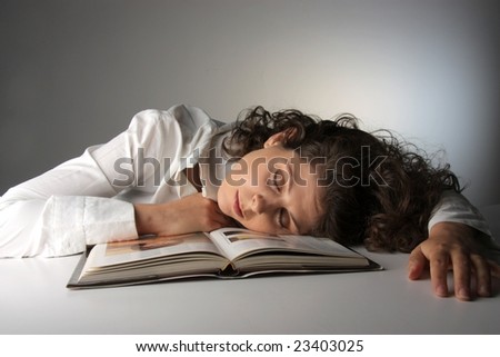 young girl sleep on the book