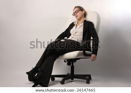 a tired beautiful businesswoman relaxing on a manager chair