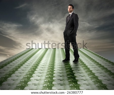 Young businessman standing on a euro banknotes floor