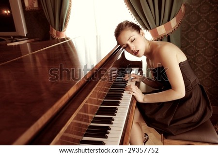 beautiful female pianist playing piano