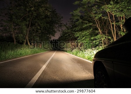 car running in a wood in the night
